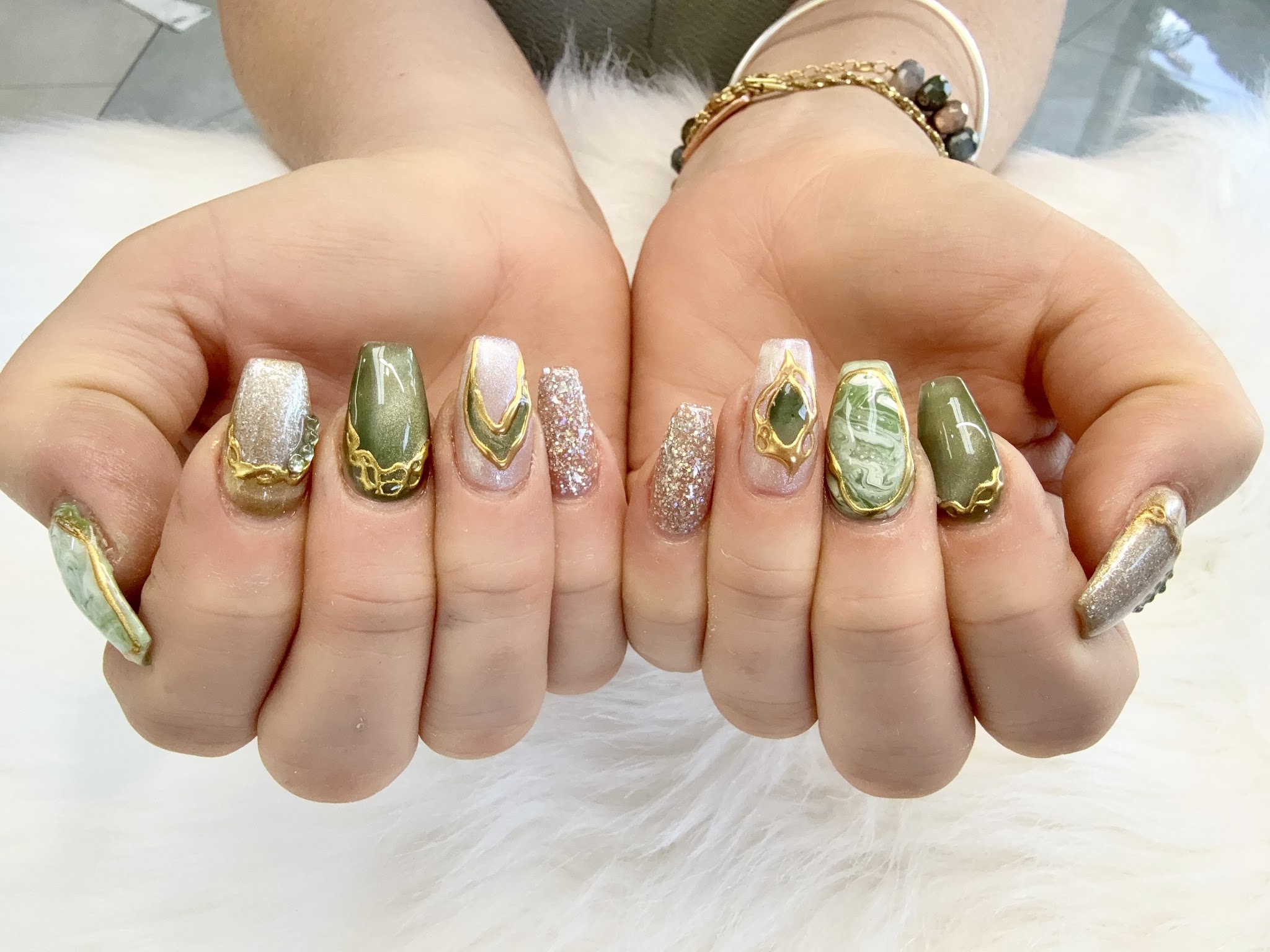 Long coffin nails with green and gold marbled jewel art