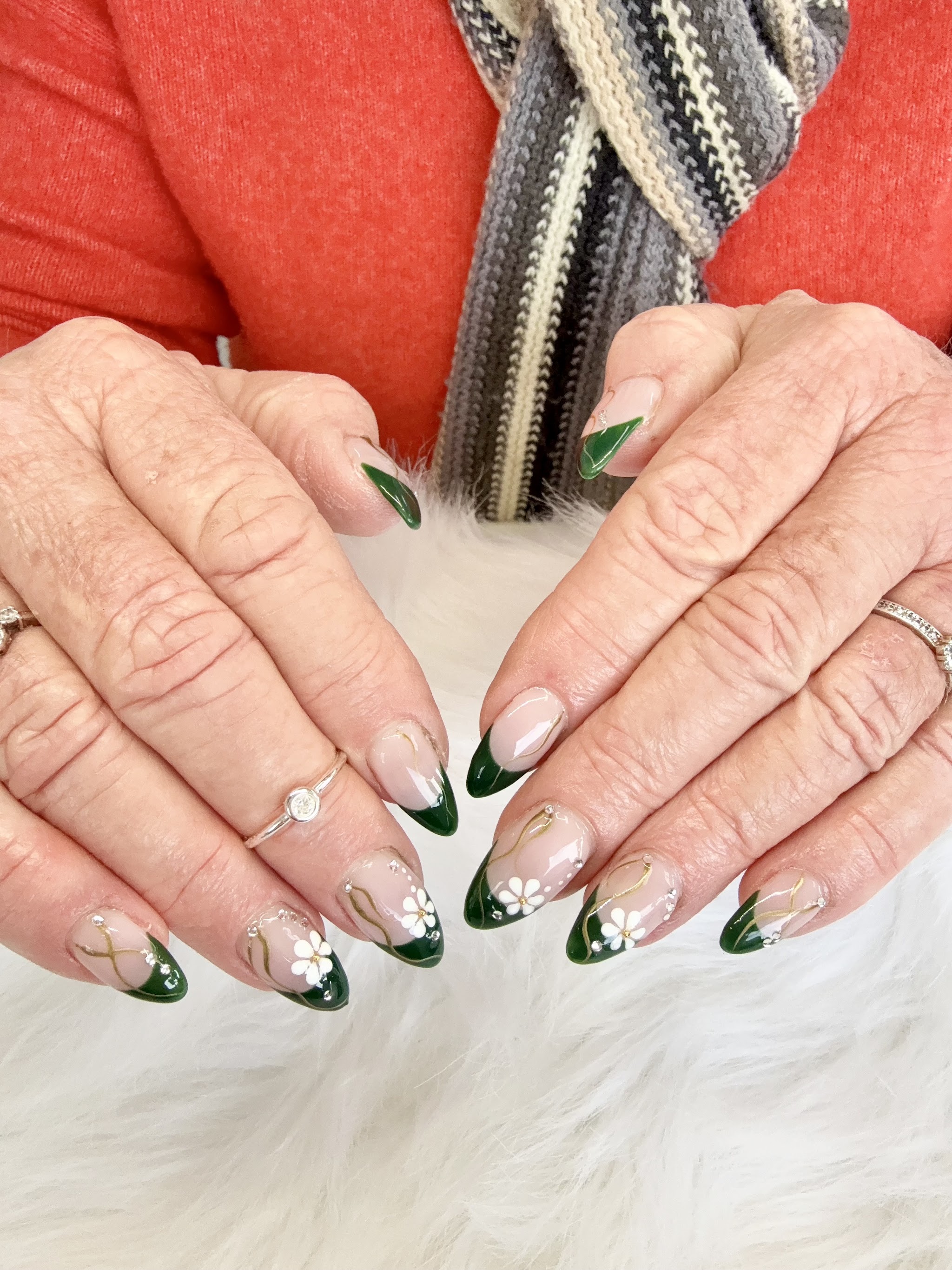 Bottle green French tips with white flowers and rhinestones