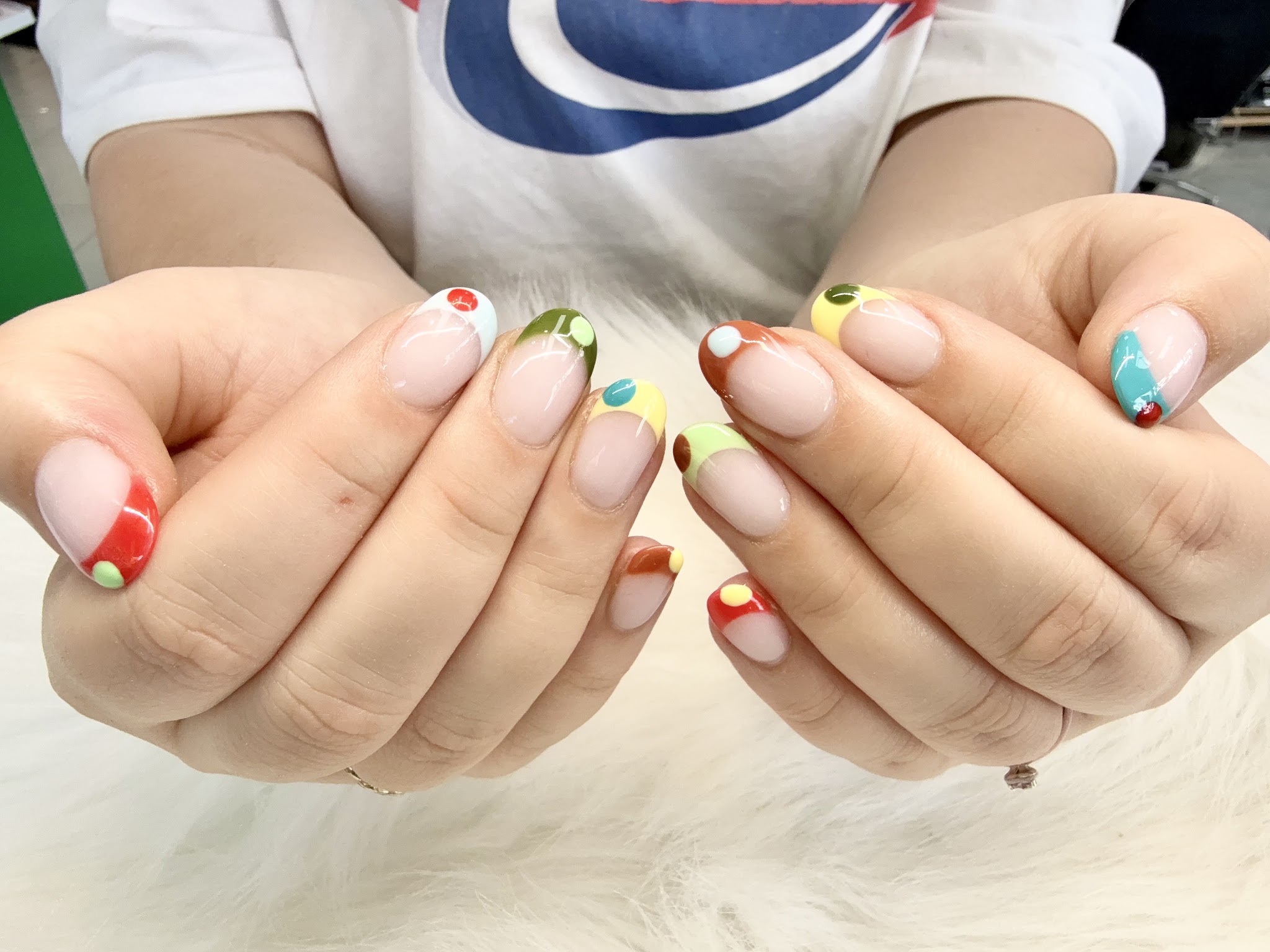 Short round nails with colourful mini French art
