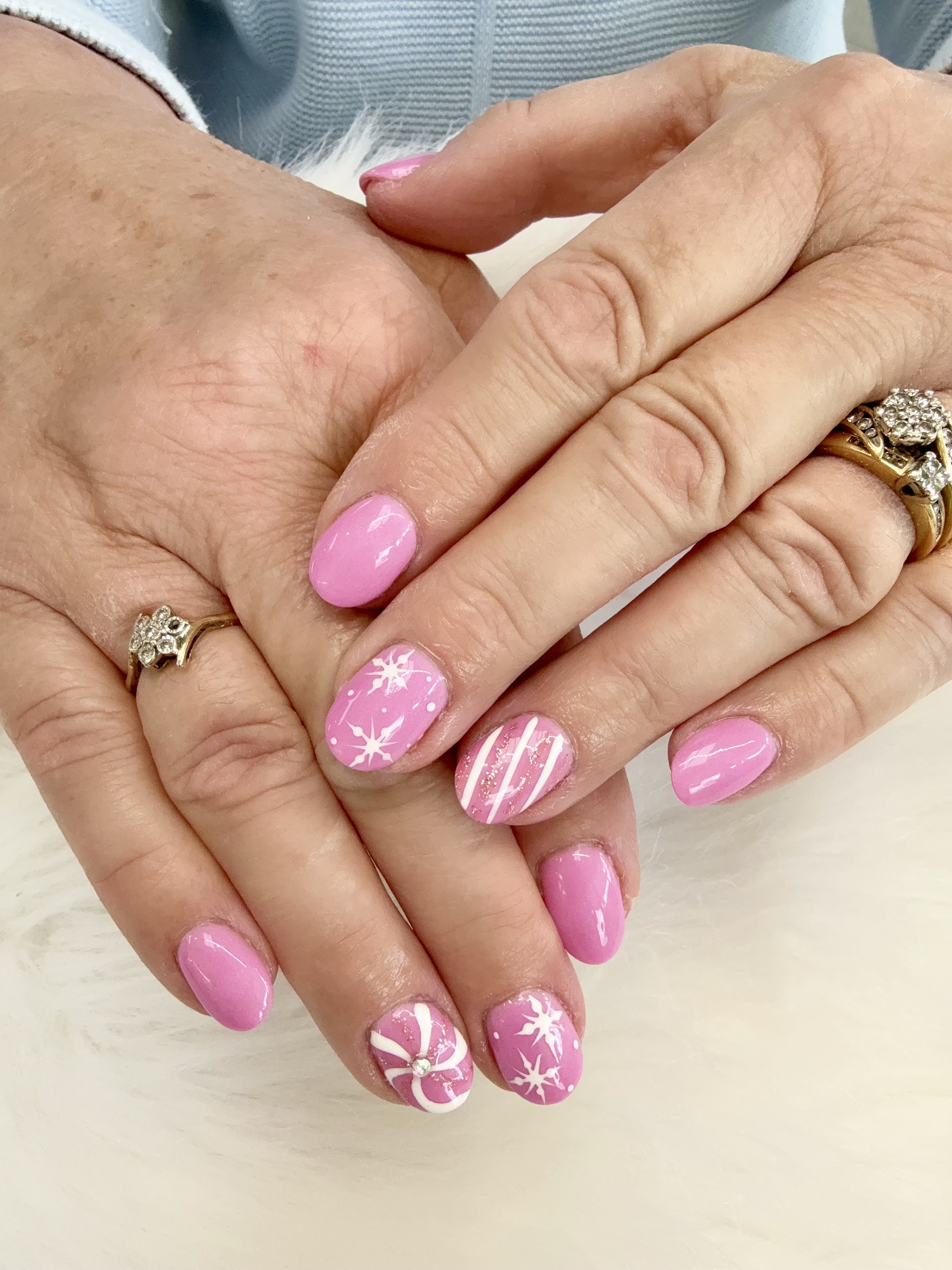 Pink gloss nails with white snowflake art